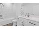 Bathroom featuring a tub and shower combo, white vanity, and black hardware at 488 Hammons Way, Atlanta, GA 30315