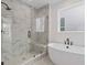 Elegant bathroom featuring a glass shower, soaking tub, and natural light at 488 Hammons Way, Atlanta, GA 30315