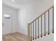 Bright foyer features light wood floors and an elegant staircase with black iron railings at 488 Hammons Way, Atlanta, GA 30315