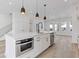 Modern kitchen featuring a large center island with stainless steel microwave and an open floor plan at 488 Hammons Way, Atlanta, GA 30315