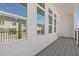 Covered patio with black metal railing, wood-look floor and exterior views through the windows at 488 Hammons Way, Atlanta, GA 30315