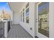 Covered patio with black metal railing, wood-look floor and exterior views through the windows at 488 Hammons Way, Atlanta, GA 30315