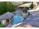 An aerial view of a backyard featuring a pool, a cabana, a hot tub and a lovely seating area at 2679 Wynnton Dr, Duluth, GA 30097