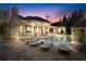 Night view of backyard with a pool, hot tub, covered patio, and ample lounge seating for nighttime relaxation at 2679 Wynnton Dr, Duluth, GA 30097