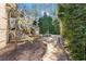 Backyard patio with stone firepit, outdoor seating, lush landscaping, and outdoor cooking area at 2679 Wynnton Dr, Duluth, GA 30097