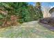 View of the backyard showing healthy green grass, mature trees and side of the house with brick facade at 2679 Wynnton Dr, Duluth, GA 30097