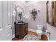 Powder room features a dark wood vanity and decorative mirror at 2679 Wynnton Dr, Duluth, GA 30097