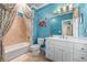 Upstairs bathroom showcasing a tub with shower, commode, and blue accent walls at 2679 Wynnton Dr, Duluth, GA 30097