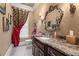 Elegant powder room featuring a marble countertop, ornate mirror, and decorative sconces at 2679 Wynnton Dr, Duluth, GA 30097