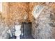 Bathroom featuring rustic stone walls, a vessel sink, and a decorative diamond-shaped window at 2679 Wynnton Dr, Duluth, GA 30097