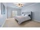 Comfortable bedroom with a plush bed, soft carpet, and natural light from the window at 2679 Wynnton Dr, Duluth, GA 30097
