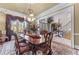 Formal dining room with traditional furnishings, elegant chandelier, and ample natural light at 2679 Wynnton Dr, Duluth, GA 30097