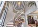Grand foyer with a curved staircase, decorative iron railing, marble floors, and elegant trim at 2679 Wynnton Dr, Duluth, GA 30097