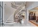 Grand foyer with a curved staircase, decorative iron railing, marble floors and elegant trim at 2679 Wynnton Dr, Duluth, GA 30097