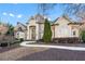 Elegant brick and stucco home featuring a graceful walkway, manicured landscaping, and architectural details at 2679 Wynnton Dr, Duluth, GA 30097
