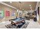 Finished basement including an area with a billiard table, stone fireplace, and full wet bar for entertaining at 2679 Wynnton Dr, Duluth, GA 30097