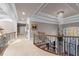Upstairs hallway with wrought iron railings, decorative trim, and chandelier at 2679 Wynnton Dr, Duluth, GA 30097
