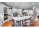 Open concept kitchen boasts a large central island, custom cabinetry, and pendant lighting at 2679 Wynnton Dr, Duluth, GA 30097