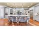 Open kitchen with island seating, granite countertops, stainless appliances, and modern pendant lighting at 2679 Wynnton Dr, Duluth, GA 30097