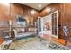 Sophisticated living room showcasing wood-paneled walls, hardwood floors, and french doors to the foyer at 2679 Wynnton Dr, Duluth, GA 30097