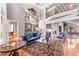 Elegant living room featuring tall ceilings, large windows, and an open view of the staircase at 2679 Wynnton Dr, Duluth, GA 30097