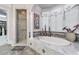 Elegant main bathroom with marble-surround tub, tiled shower, and large window at 2679 Wynnton Dr, Duluth, GA 30097