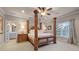 Elegant main bedroom featuring a four-poster bed and adjoining bath at 2679 Wynnton Dr, Duluth, GA 30097