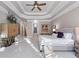 Spacious main bedroom with tray ceiling, sitting area, and doorway to en suite bathroom at 2679 Wynnton Dr, Duluth, GA 30097