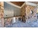 Outdoor kitchen with stainless appliances, stone accents, and a mosaic backsplash, perfect for entertaining by the pool at 2679 Wynnton Dr, Duluth, GA 30097