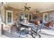 Covered patio with brick columns, ceiling fans, and outdoor dining area at 2679 Wynnton Dr, Duluth, GA 30097