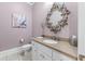 Charming powder room featuring a decorative mirror and light purple walls at 2679 Wynnton Dr, Duluth, GA 30097