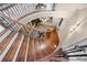 Elegant curved staircase with wrought iron railings and wood steps at 2679 Wynnton Dr, Duluth, GA 30097