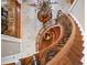 Sweeping staircase with wooden banister and wrought iron accents at 2679 Wynnton Dr, Duluth, GA 30097
