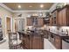 Basement wet bar features dark wood cabinetry, granite countertops, and stainless steel appliances for modern convenience at 2679 Wynnton Dr, Duluth, GA 30097