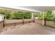 The back porch of this home provides a relaxing space with wood floors and a lattice-style railing at 3390 Navaho Se Trl, Smyrna, GA 30080