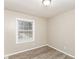 This bedroom features neutral walls, modern flooring, a window and a ceiling light at 3390 Navaho Se Trl, Smyrna, GA 30080