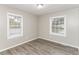 Bright bedroom featuring new floors and two large windows at 3390 Navaho Se Trl, Smyrna, GA 30080
