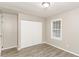 This bedroom features neutral walls, modern flooring, and a closet for optimal storage space at 3390 Navaho Se Trl, Smyrna, GA 30080