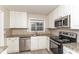 Well-lit kitchen with stainless steel appliances, granite countertops, and mosaic backsplash at 3390 Navaho Se Trl, Smyrna, GA 30080