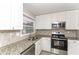 Updated kitchen featuring stainless steel appliances, granite countertops, and white cabinets at 3390 Navaho Se Trl, Smyrna, GA 30080