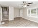 Bright living room with updated flooring, a ceiling fan, and a large window at 3390 Navaho Se Trl, Smyrna, GA 30080