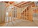 Unfinished basement with wood frame, concrete floor, and exposed ceiling, presenting a blank canvas for your dream space at 1496 Rocky River Dr, Lawrenceville, GA 30045