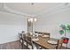 Charming dining area with an oak dining table, chandelier, and wainscoting details at 1496 Rocky River Dr, Lawrenceville, GA 30045