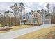 Stunning two-story home with long driveway and three-car garage in wooded lot at 1496 Rocky River Dr, Lawrenceville, GA 30045