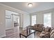 Inviting living room featuring hardwood floors and an open layout to the dining area at 1496 Rocky River Dr, Lawrenceville, GA 30045