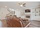 Relaxing living room featuring a brick fireplace, built-in shelves, and hardwood floors at 1496 Rocky River Dr, Lawrenceville, GA 30045