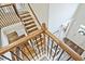 Staircase with wooden treads, iron railings, and carpeted landings at 1496 Rocky River Dr, Lawrenceville, GA 30045