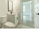 Clean and modern half bath showcasing a white vanity with a black faucet and a view into a light-filled bedroom at 1514 Gatekeeper Ter, Marietta, GA 30066