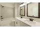 Modern bathroom with double vanity, sleek fixtures, and a shower-tub combo at 1514 Gatekeeper Ter, Marietta, GA 30066