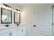 Bathroom featuring double vanities, two mirrors, and modern light fixtures at 1514 Gatekeeper Ter, Marietta, GA 30066